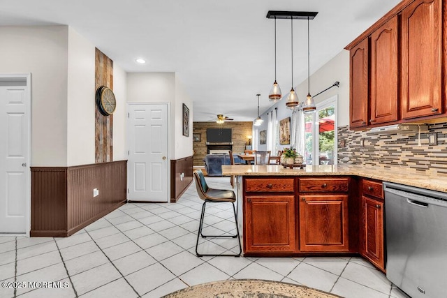 9 Kindling Way, Jackson, NJ 08527 - kitchen featuring stainless steel dishwasher, ceiling fan, a peninsula, open floor plan, and light stone countertops