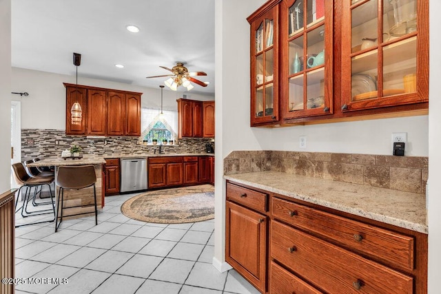 9 Kindling Way, Jackson, NJ 08527 - kitchen featuring stainless steel dishwasher, tasteful backsplash, a ceiling fan, glass insert cabinets, and light tile patterned floors