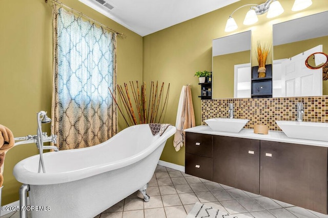 9 Kindling Way, Jackson, NJ 08527 - bathroom featuring double vanity, decorative backsplash, a freestanding tub, tile patterned flooring, and baseboards