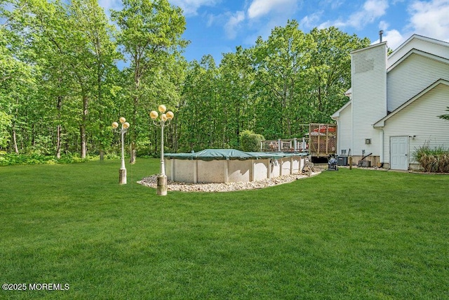 9 Kindling Way, Jackson, NJ 08527 - view of green lawn featuring a covered pool and a wooden deck