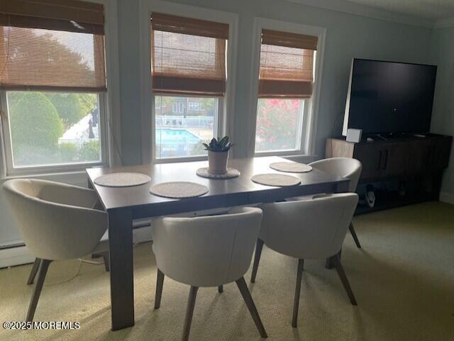310 Maryland Ave Unit 11B, Point Pleasant Beach, NJ 08742 - dining area with healthy amount of natural light, carpet flooring, and ornamental molding