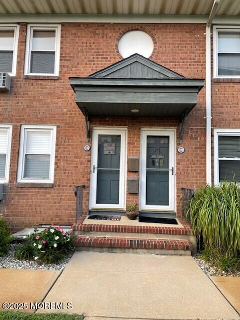 310 Maryland Ave Unit 11B, Point Pleasant Beach, NJ 08742 - view of exterior entry featuring brick siding and cooling unit