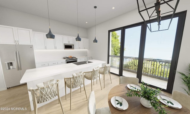 3 5th Ave Unit 104, Neptune City, NJ 07753 - kitchen with stainless steel appliances, a sink, light countertops, light wood-type flooring, and a center island with sink