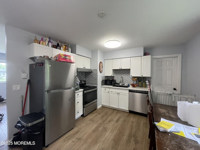 442 Bay Way, Lanoka Harbor, NJ 08734 - kitchen with appliances with stainless steel finishes, under cabinet range hood, tasteful backsplash, and white cabinetry