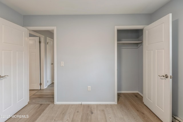 442 Bay Way, Lanoka Harbor, NJ 08734 - unfurnished bedroom featuring baseboard heating, wood finished floors, a closet, and baseboards