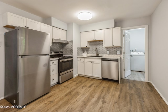 442 Bay Way, Lanoka Harbor, NJ 08734 - kitchen with appliances with stainless steel finishes, washer / clothes dryer, a sink, under cabinet range hood, and backsplash