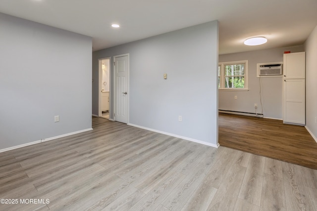 442 Bay Way, Lanoka Harbor, NJ 08734 - empty room with a baseboard heating unit, an AC wall unit, light wood-style floors, recessed lighting, and baseboards