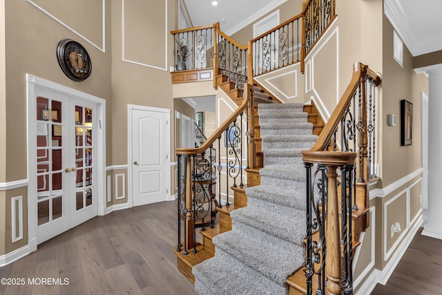 209 Shepard Way, Manalapan, NJ 07726 - stairs with ornamental molding, french doors, wood finished floors, a towering ceiling, and decorative columns