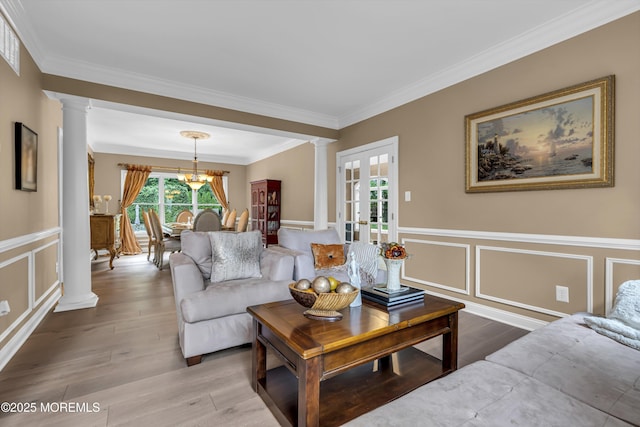 209 Shepard Way, Manalapan, NJ 07726 - living room with decorative columns, a decorative wall, ornamental molding, wood finished floors, and wainscoting