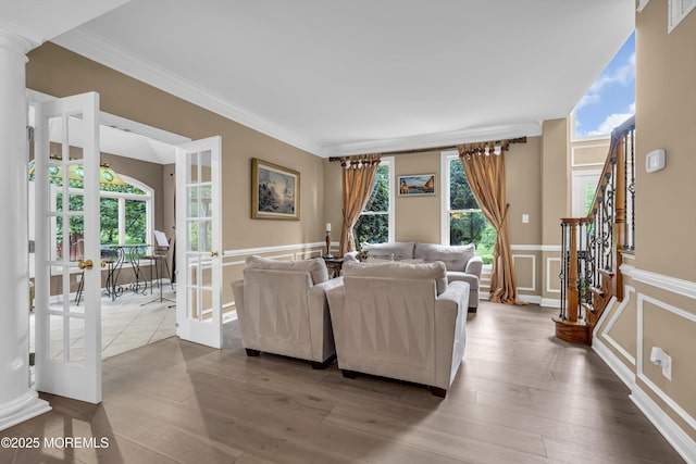 209 Shepard Way, Manalapan, NJ 07726 - living room with a wainscoted wall, french doors, ornamental molding, a decorative wall, and stairs