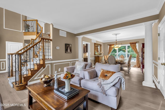 209 Shepard Way, Manalapan, NJ 07726 - living room with decorative columns, stairs, wood finished floors, a decorative wall, and ornamental molding