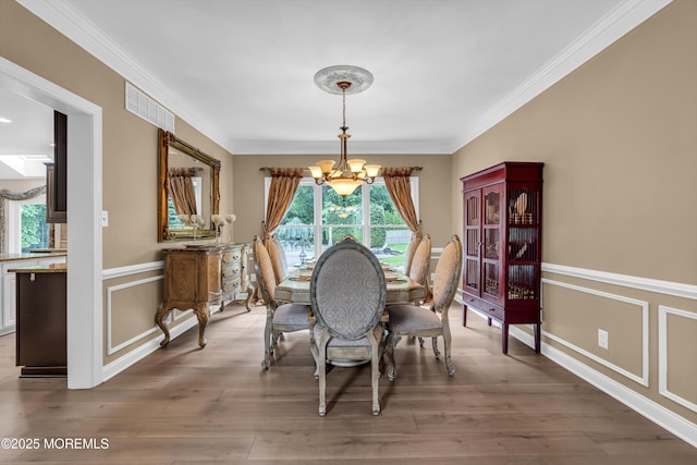 209 Shepard Way, Manalapan, NJ 07726 - dining room with a chandelier, crown molding, and wood finished floors