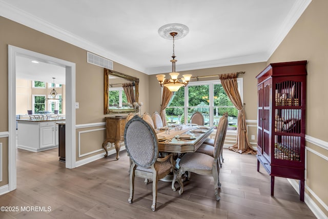 209 Shepard Way, Manalapan, NJ 07726 - dining room with a chandelier, ornamental molding, wainscoting, and wood finished floors