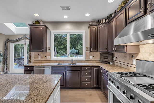 209 Shepard Way, Manalapan, NJ 07726 - kitchen featuring a sink, exhaust hood, a skylight, appliances with stainless steel finishes, and dark brown cabinets
