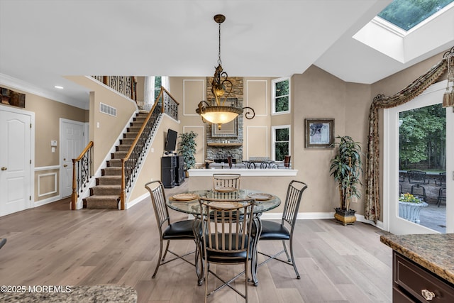 209 Shepard Way, Manalapan, NJ 07726 - dining area with a skylight, plenty of natural light, light wood-style flooring, and stairs