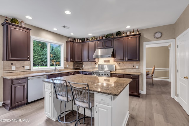 209 Shepard Way, Manalapan, NJ 07726 - kitchen featuring dishwasher, stove, under cabinet range hood, a sink, and dark brown cabinetry