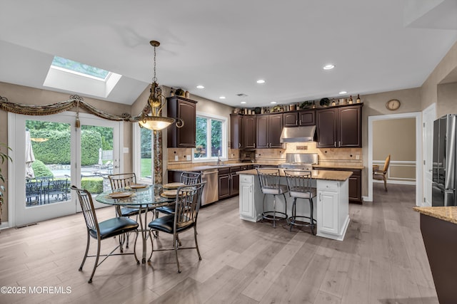 209 Shepard Way, Manalapan, NJ 07726 - kitchen with under cabinet range hood, a skylight, appliances with stainless steel finishes, a sink, and dark brown cabinetry