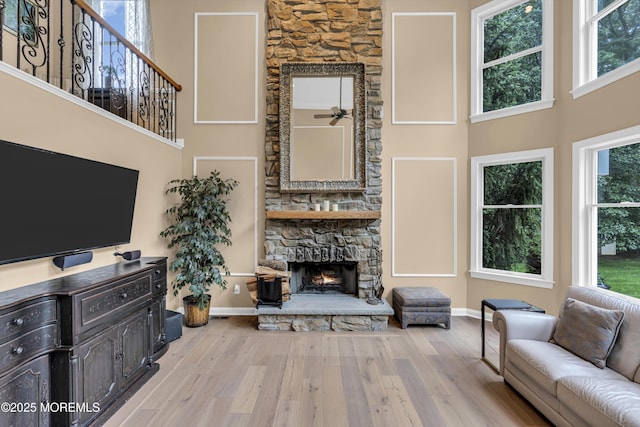 209 Shepard Way, Manalapan, NJ 07726 - living room with wood finished floors, a fireplace, a high ceiling, and baseboards