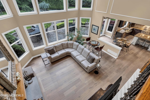 209 Shepard Way, Manalapan, NJ 07726 - living area with a high ceiling, wood finished floors, and baseboards