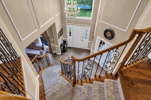 209 Shepard Way, Manalapan, NJ 07726 - entrance foyer featuring a chandelier, healthy amount of natural light, a high ceiling, wood finished floors, and stairs