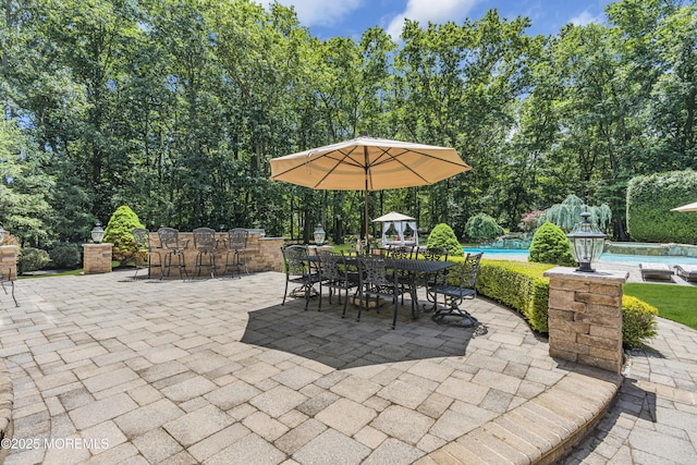 209 Shepard Way, Manalapan, NJ 07726 - view of patio with a pool, outdoor dining area, and view of wooded area