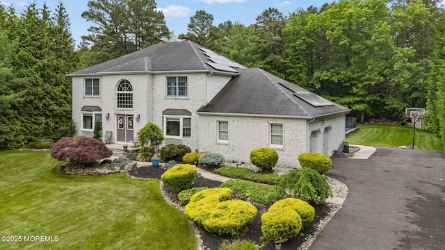 6 Overlook Dr, Jackson, NJ 08527 - view of front of property with a garage, a front yard, solar panels, asphalt driveway, and brick siding