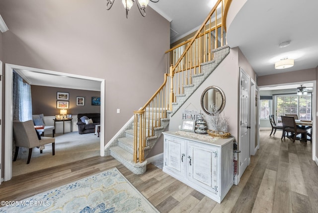 6 Overlook Dr, Jackson, NJ 08527 - stairway with wood finished floors, ornamental molding, a chandelier, baseboards, and ceiling fan