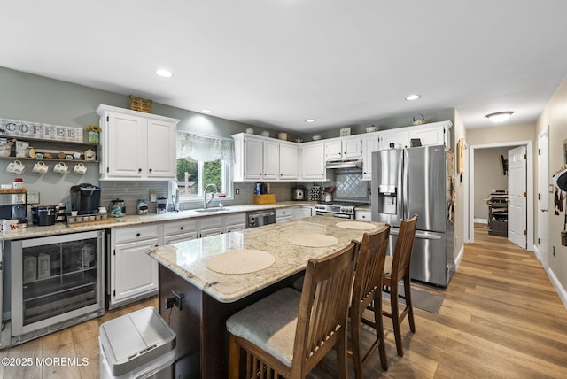 6 Overlook Dr, Jackson, NJ 08527 - kitchen with stainless steel appliances, wine cooler, a sink, backsplash, and white cabinetry