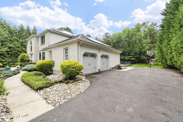 6 Overlook Dr, Jackson, NJ 08527 - view of side of property with brick siding, asphalt driveway, solar panels, and an attached garage