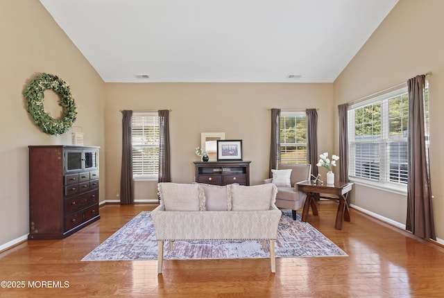 8 Chaminox Ct, Manchester, NJ 08759 - living area with wood finished floors, lofted ceiling, and baseboards