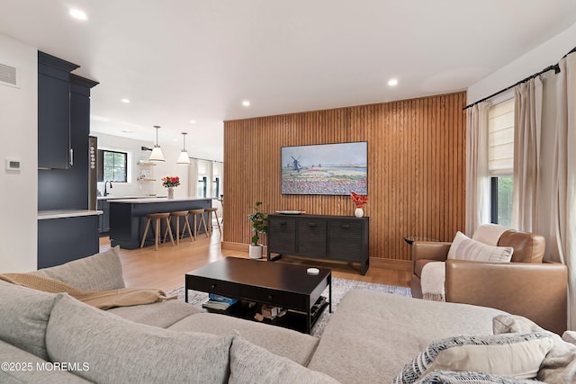 405 Ludlow Ave, Spring Lake, NJ 07762 - living area featuring light wood-style floors, recessed lighting, an accent wall, and wooden walls