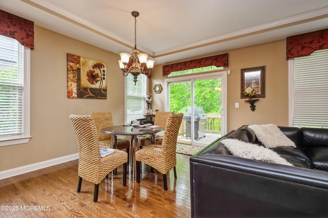 63 Wintergreen Dr, Manalapan, NJ 07726 - dining space with a chandelier, wood finished floors, baseboards, crown molding, and a raised ceiling