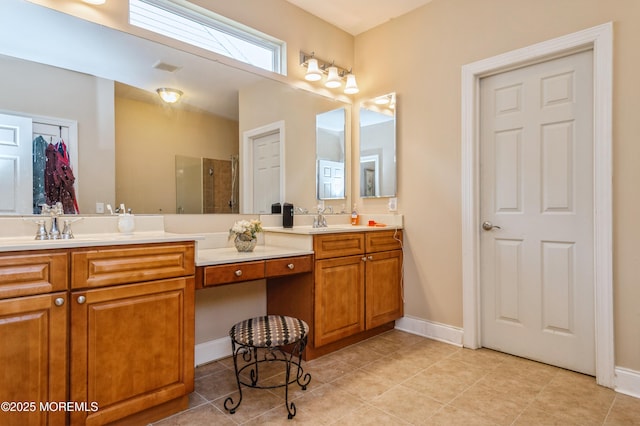 63 Wintergreen Dr, Manalapan, NJ 07726 - full bathroom with double vanity, a tile shower, tile patterned flooring, and baseboards