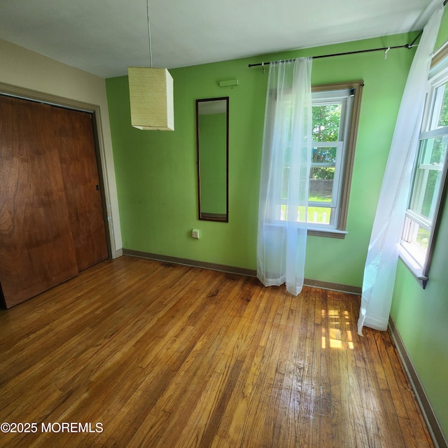 2102 Princeton Pike, Lawrence, NJ 08648 - unfurnished bedroom featuring hardwood / wood-style floors, baseboards, and a closet