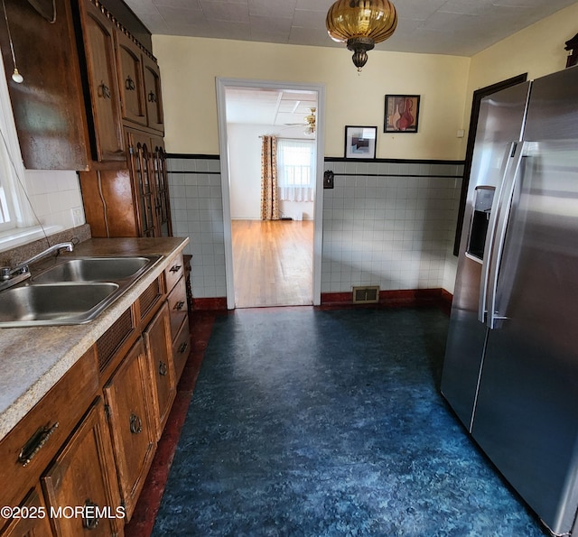 2102 Princeton Pike, Lawrence, NJ 08648 - kitchen with stainless steel fridge, a sink, tile walls, a ceiling fan, and wainscoting