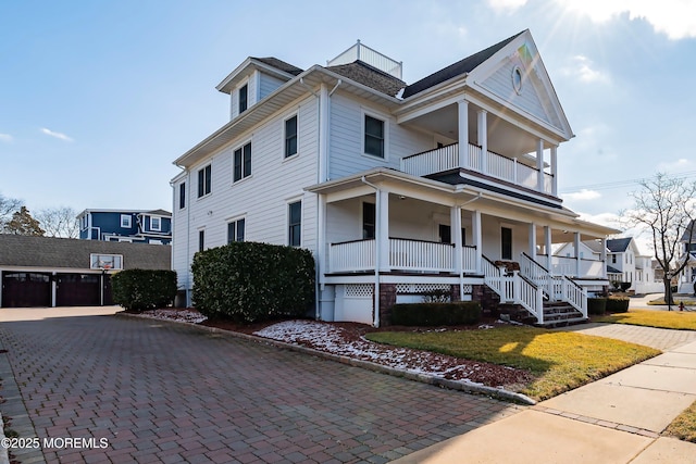 304 8th Ave, Belmar, NJ 07719 - view of front of house with a balcony, covered porch, a garage, and a front lawn