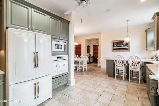 304 8th Ave, Belmar, NJ 07719 - kitchen with fridge, crown molding, white microwave, light countertops, and ceiling fan