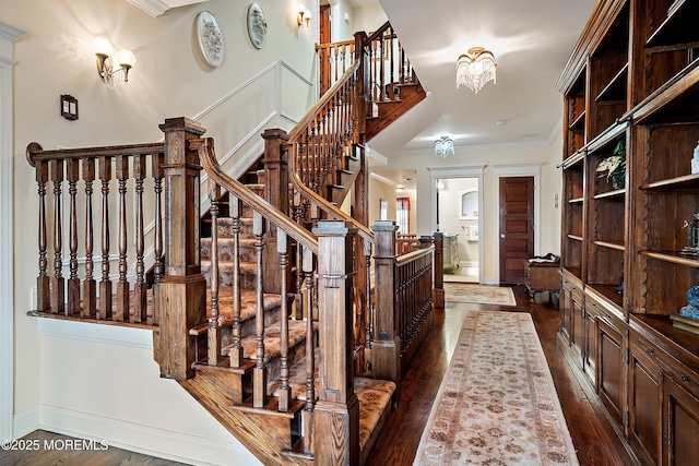 304 8th Ave, Belmar, NJ 07719 - stairway featuring hardwood / wood-style floors, ornamental molding, and a chandelier