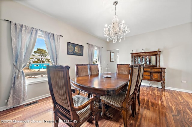 128 E Delaware Dr, Little Egg Harbor, NJ 08087 - dining room with a chandelier, wood finished floors, and baseboards