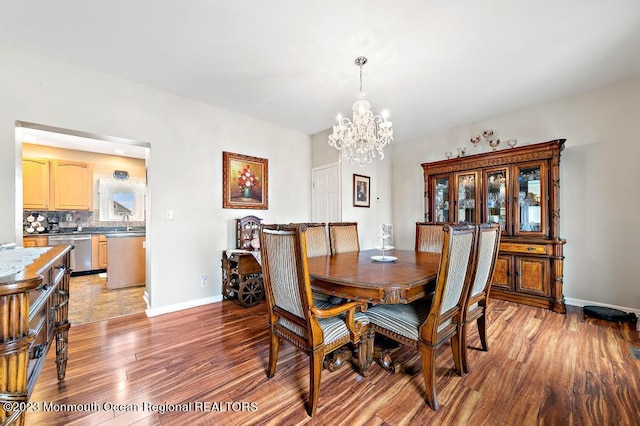 128 E Delaware Dr, Little Egg Harbor, NJ 08087 - dining room with a chandelier, light wood finished floors, and baseboards