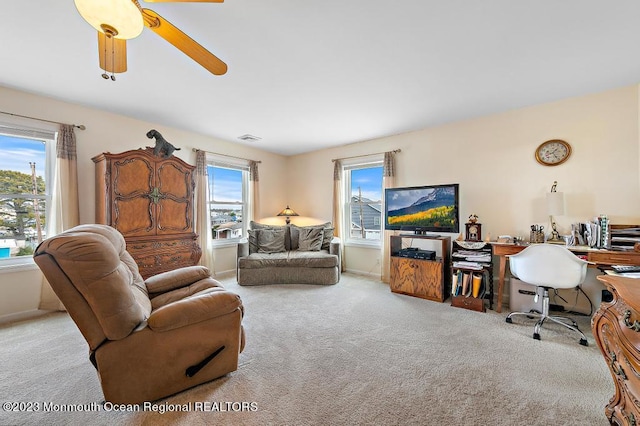 128 E Delaware Dr, Little Egg Harbor, NJ 08087 - carpeted living room with a ceiling fan, a desk, and baseboards