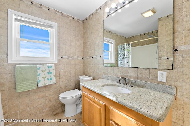 128 E Delaware Dr, Little Egg Harbor, NJ 08087 - bathroom featuring tile walls, vanity, toilet, a shower with curtain, and tile patterned flooring