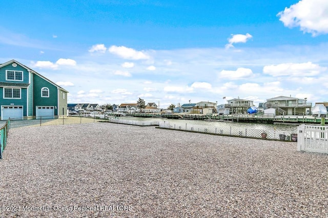 128 E Delaware Dr, Little Egg Harbor, NJ 08087 - view of home's community featuring a garage, a water view, a residential view, and driveway
