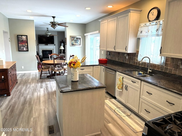 128 E Delaware Dr, Little Egg Harbor, NJ 08087 - kitchen featuring stainless steel dishwasher, a sink, ceiling fan, light wood-style floors, and backsplash