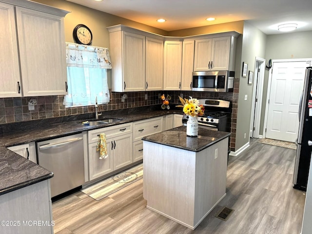 128 E Delaware Dr, Little Egg Harbor, NJ 08087 - kitchen with stainless steel appliances, a sink, light wood-style flooring, backsplash, and recessed lighting