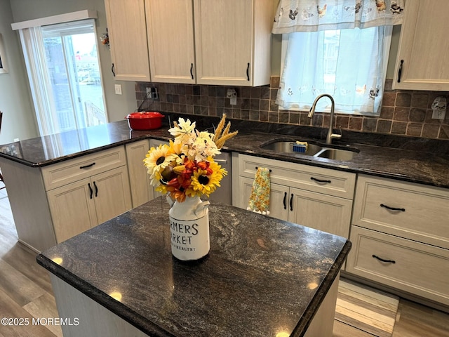 128 E Delaware Dr, Little Egg Harbor, NJ 08087 - kitchen featuring a sink, light wood-type flooring, decorative backsplash, a peninsula, and dark stone counters