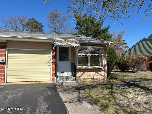 138 Hudson Pkwy Unit B, Whiting, NJ 08759 - view of front of property with brick siding, driveway, a garage, entry steps, and roof with shingles
