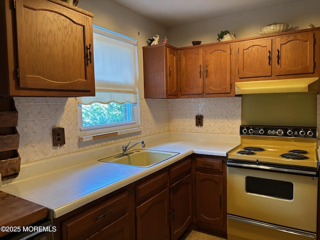 138 Hudson Pkwy Unit B, Whiting, NJ 08759 - kitchen with electric range oven, under cabinet range hood, a sink, light countertops, and decorative backsplash