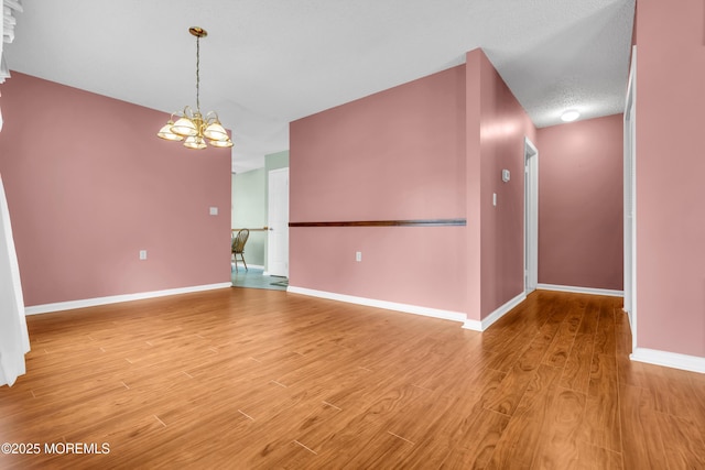 4 Beechwood Ct, Barnegat, NJ 08005 - spare room with a chandelier, light wood-style flooring, and baseboards