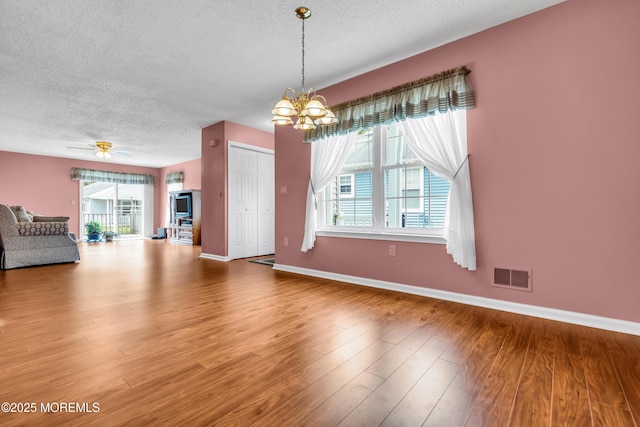 4 Beechwood Ct, Barnegat, NJ 08005 - unfurnished living room with a textured ceiling, a chandelier, wood finished floors, baseboards, and ceiling fan